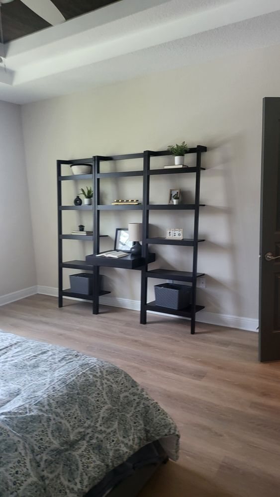 Tidy, organized guest bedroom with shelving